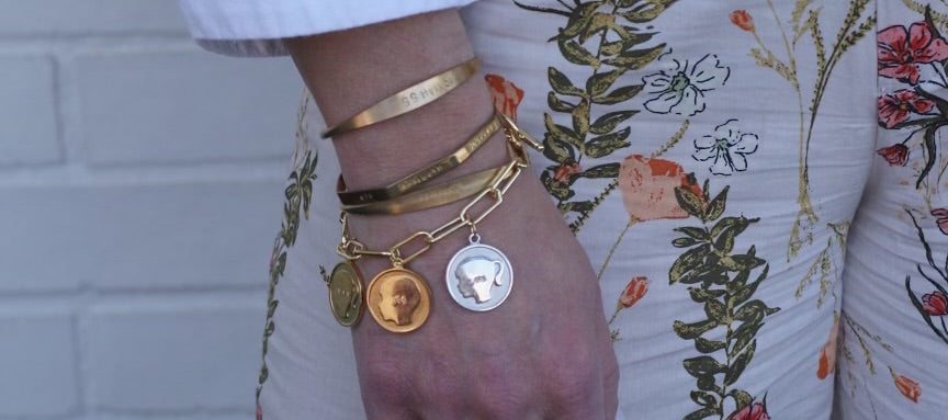 Bracelet stack: brass cuffs and charmed beloved silhouette bracelet